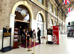 Check in for your journey on a red-carpeted platform